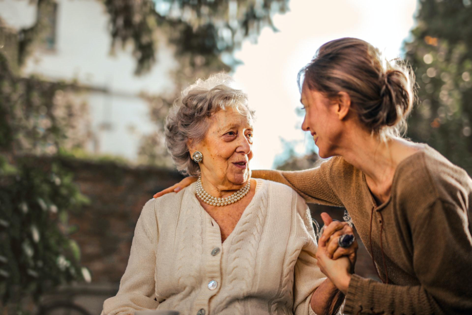 Senior woman and adult woman converse closely