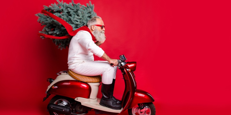 Stylish Santa rides a moped