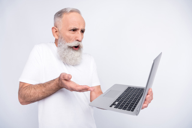 Senior Man mystified with his laptop