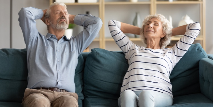 Senior couple relaxing on their couch